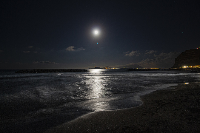 Fotografia del mare notturno illuminato dalla luna